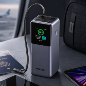 UGREEN 20000mAh 165W Nexode Smart Display Power Bank with Retractable USB-C Cable in Travel Workspace Setup