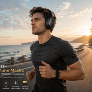 Man jogging on a seaside road wearing UGREEN HiTune Max5c Hybrid ANC Wireless Headphones during sunrise, featuring 43dB noise cancellation and premium audio quality.