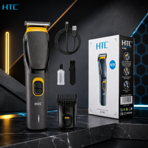 HTC AT-509 Professional Hair Trimmer complete grooming kit with USB charging cable, guide comb, cleaning brush, lubricating oil bottle, and retail box on a premium black background.
