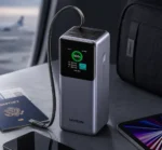 UGREEN 20000mAh 165W Nexode Smart Display Power Bank with Retractable USB-C Cable in Travel Workspace Setup
